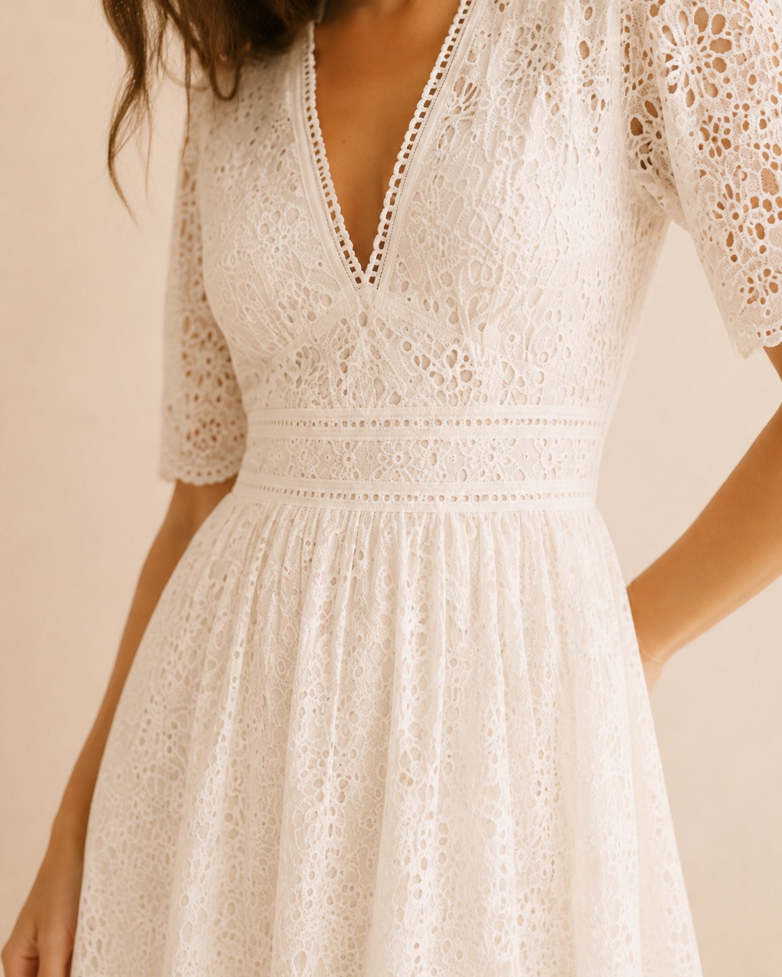 Close-up of ivory eyelet fabric and V-neckline