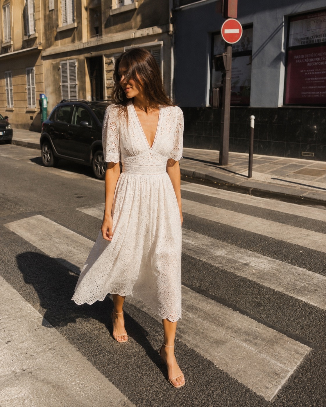 Petite model in a rose floral wrap maxi dress and flat sandals — an uninterrupted vertical line elongates the frame without heels.