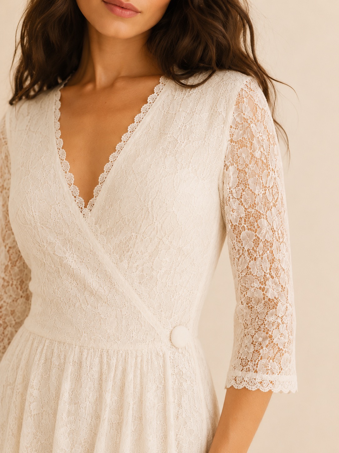 Close-up of ivory lace bodice with a single button
